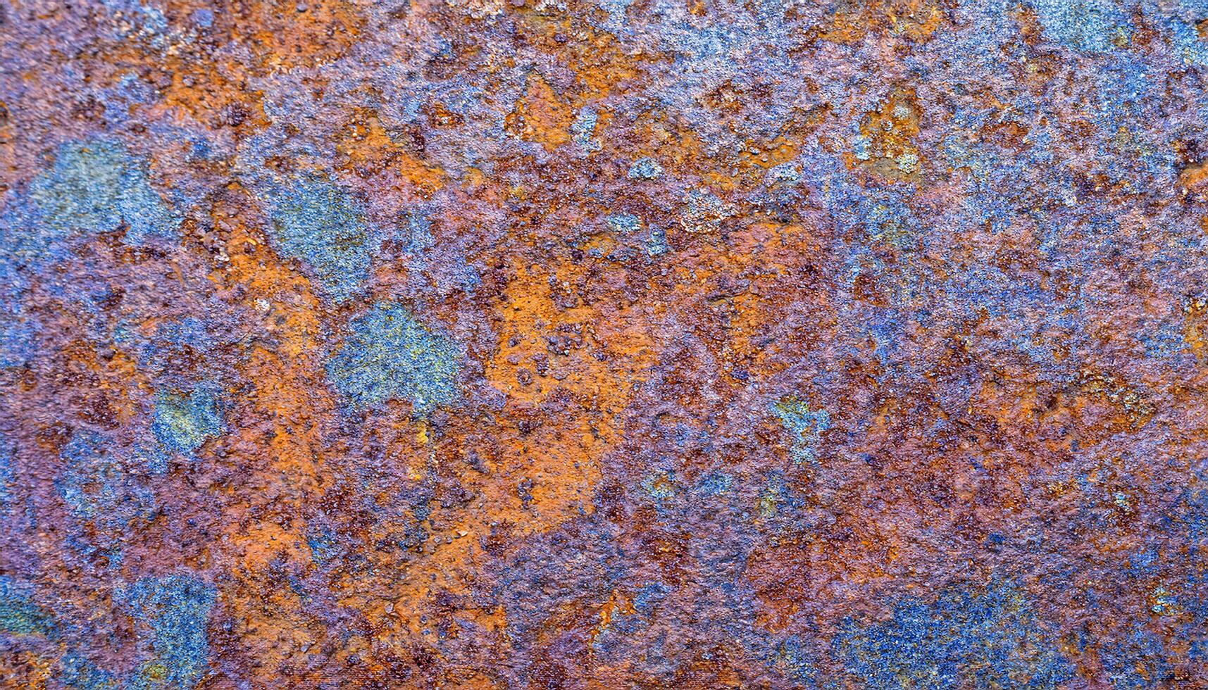 close-up of heat-treated steel with vibrant multi-colored oxidation patterns and textured surface photo