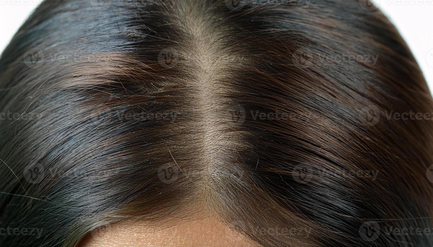 close-up of healthy scalp with shiny dark brown hair and visible hair parting for haircare and dermatology concepts photo