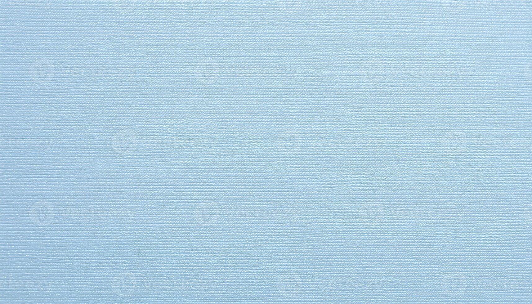 close-up of pale blue textured paper with fine embossed linen pattern for stationery and design projects photo