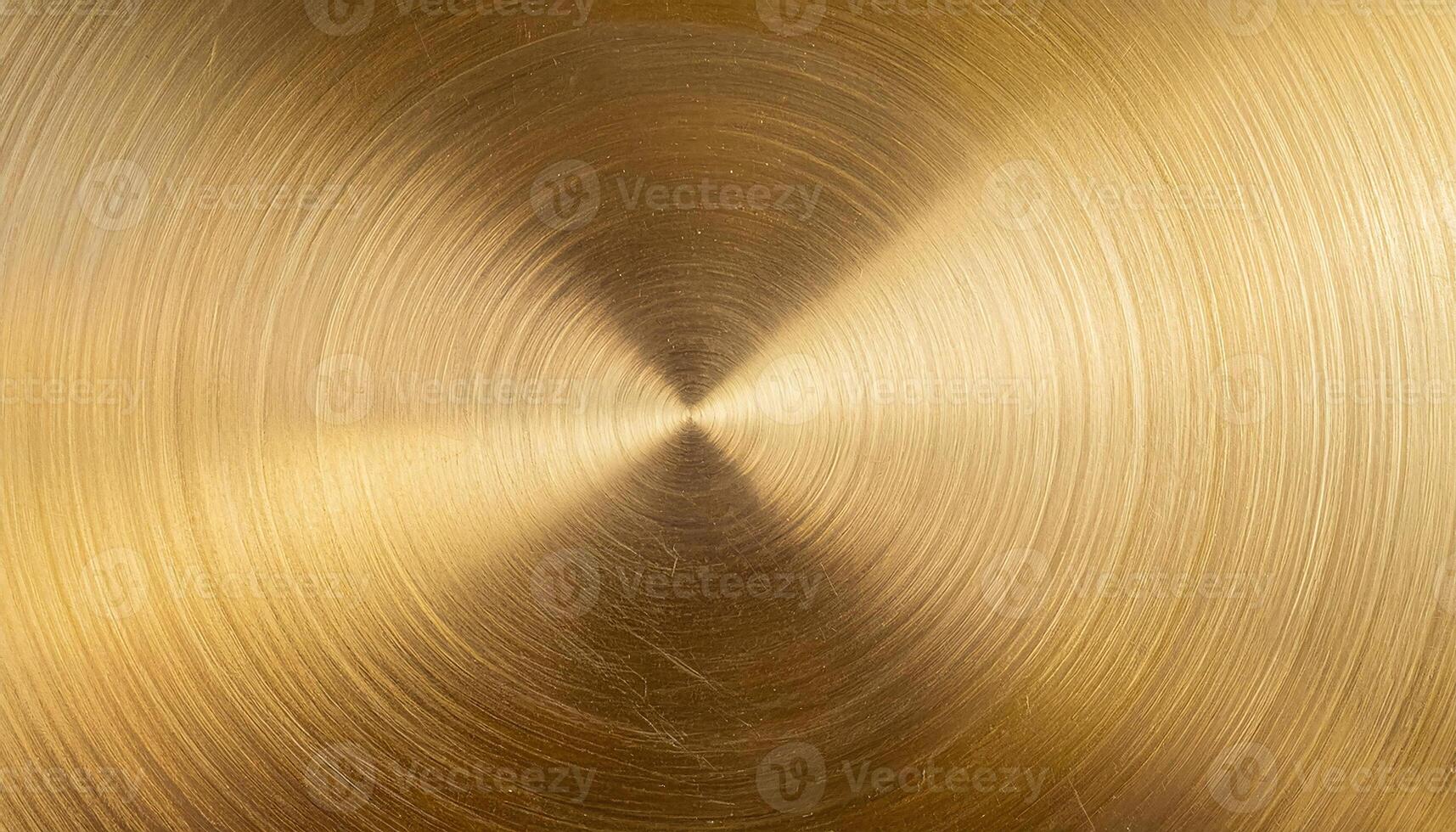 macro view of clean brass plate with concentric circular brushed texture and golden metallic finish photo