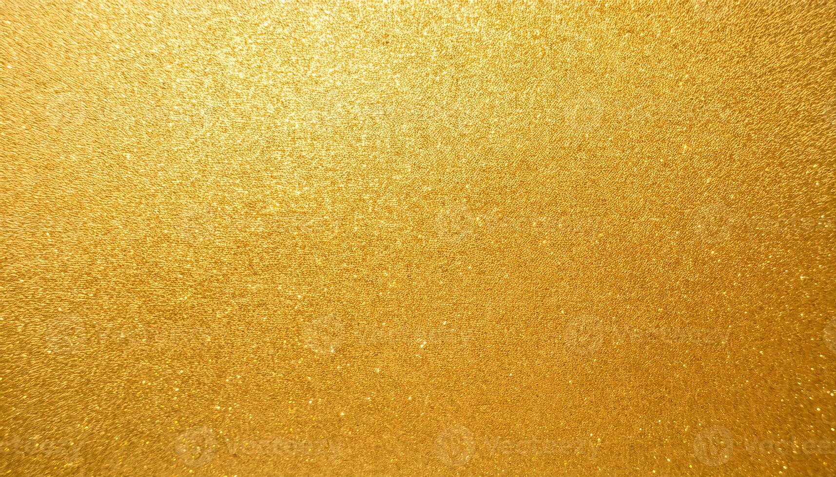 close-up of metallic gold textured paper with intense shimmering sparkles and luxurious reflective surface photo