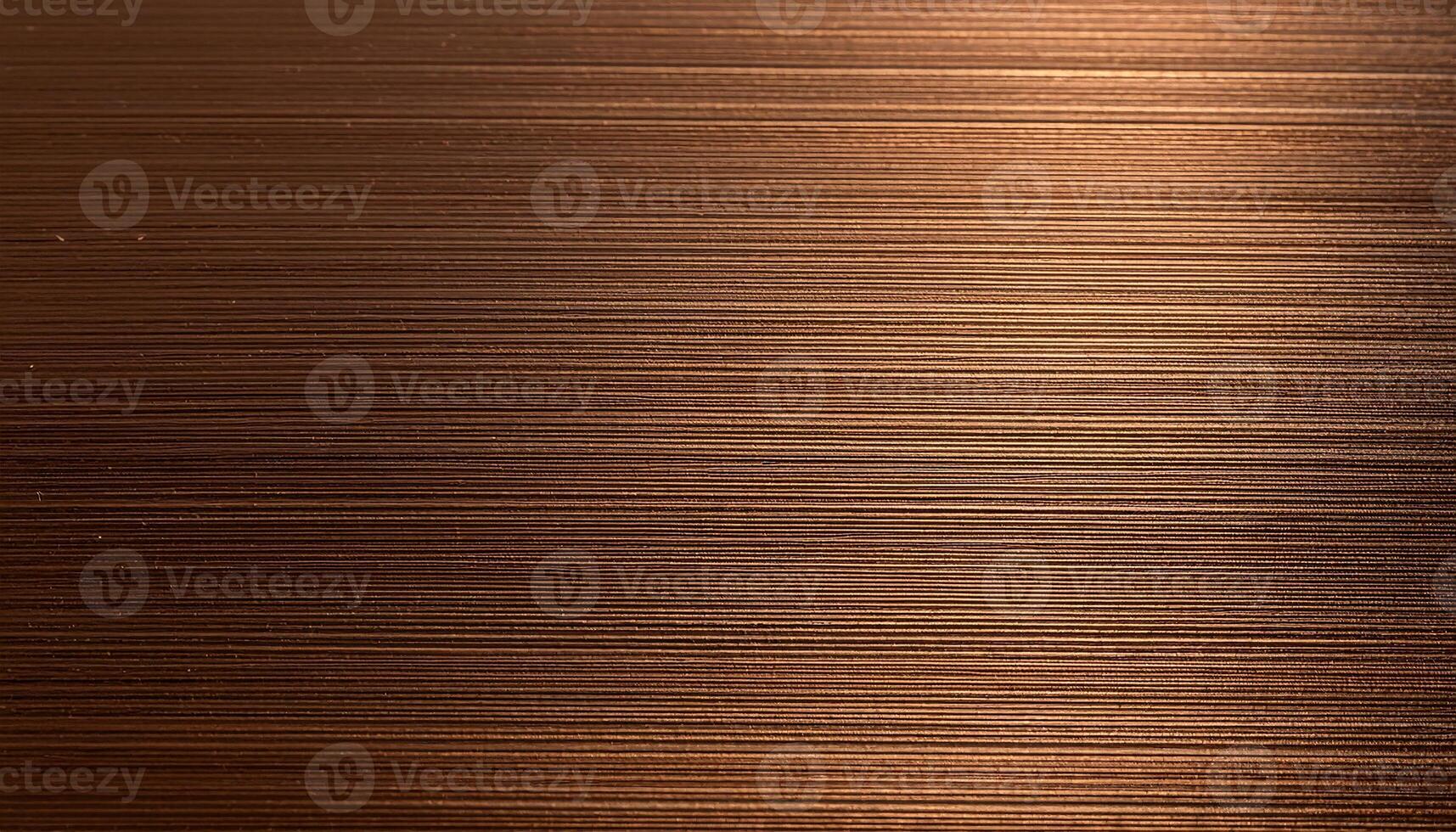 macro view of brushed bronze sheet with soft horizontal grain and metallic texture photo