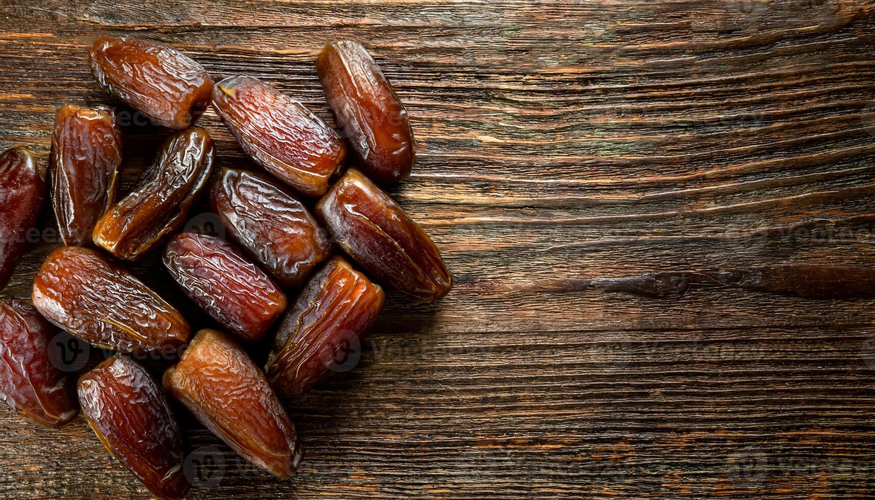 top-down view of dried dates on rustic wooden surface with ample negative space for text, organic and natural sweet snack concept photo