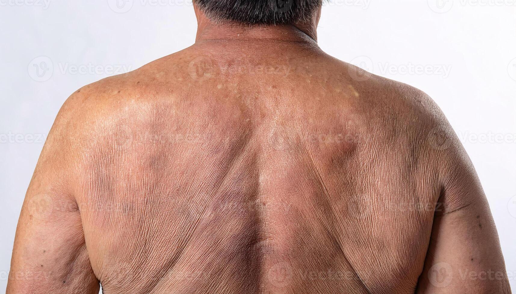 Detailed view of aged skin on the lower back, with subtle folds and pigmentation in isolated white background photo