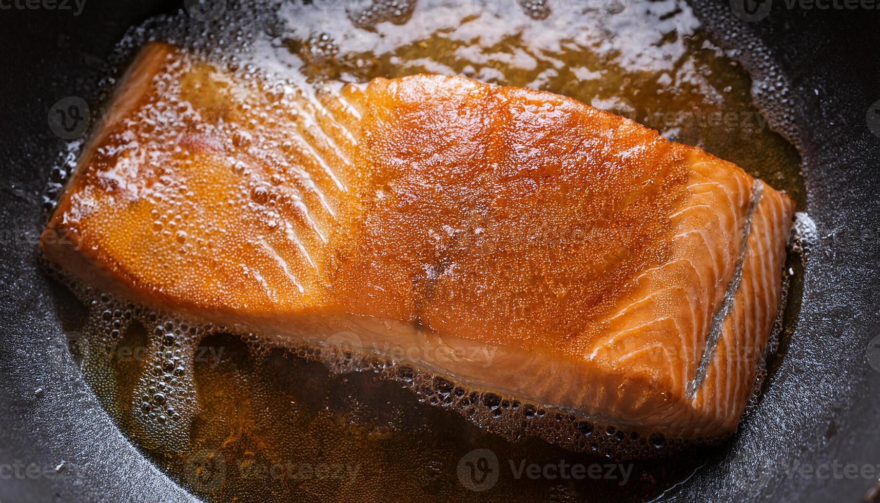 fresh salmon fillet sizzling in hot oil with crispy skin and golden textures forming during frying process photo