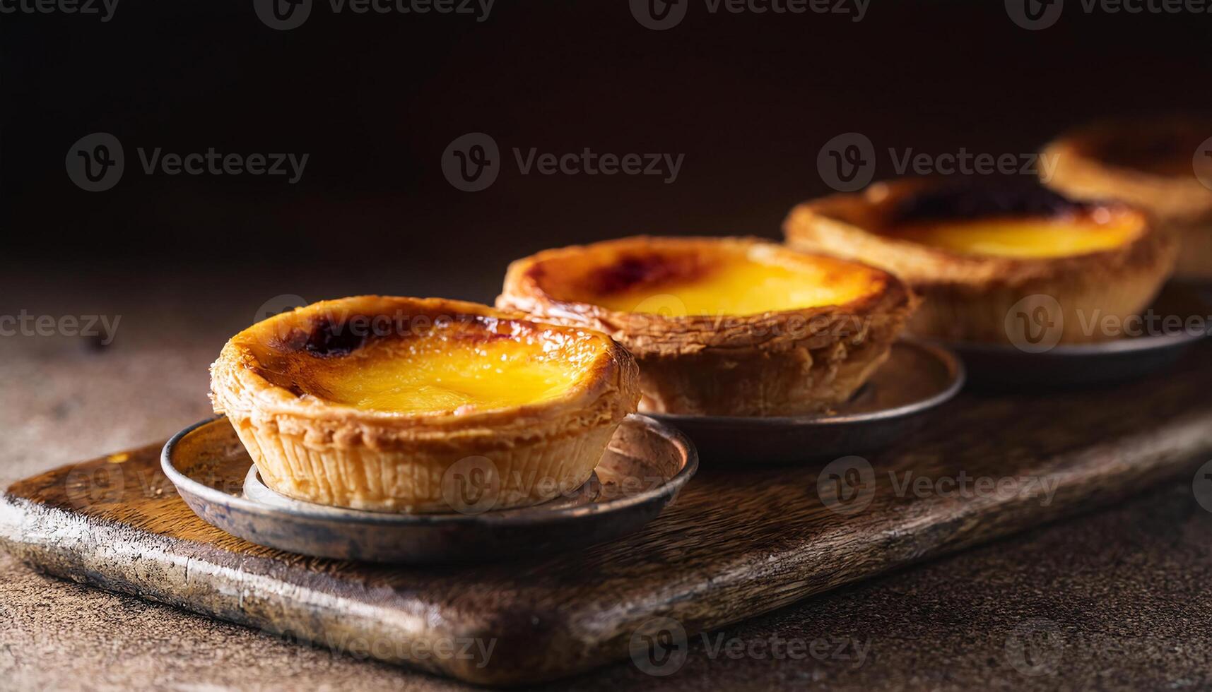 classic portuguese egg tarts with flaky crust and creamy custard filling on wooden board photo