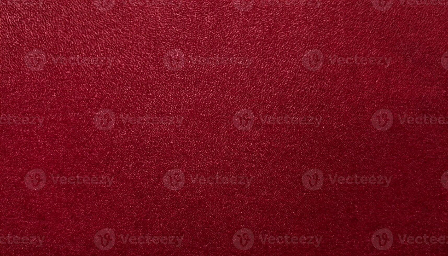 close-up of deep red velvet-finished paper with smooth surface and fine tactile texture photo