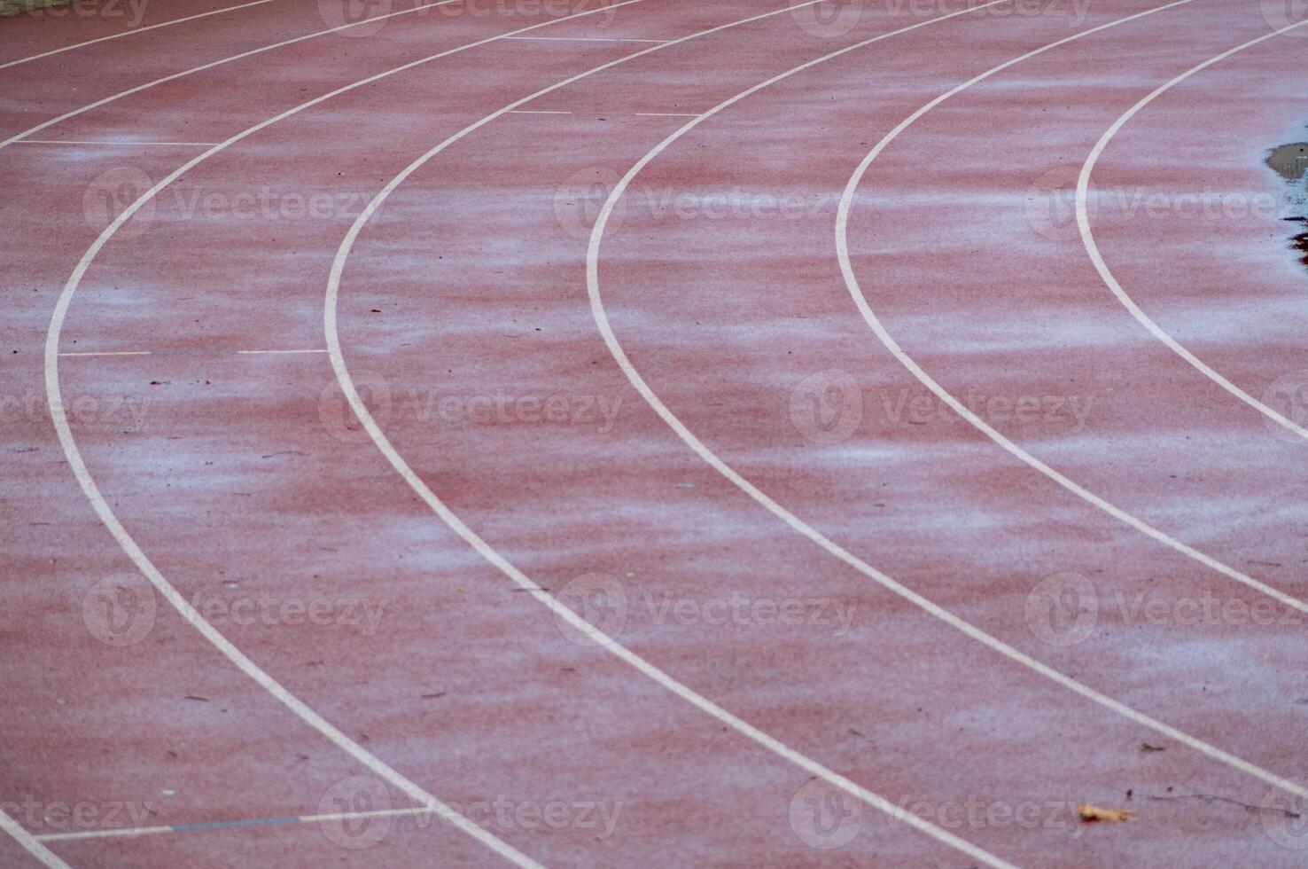 Running track covered with first snow of winter photo