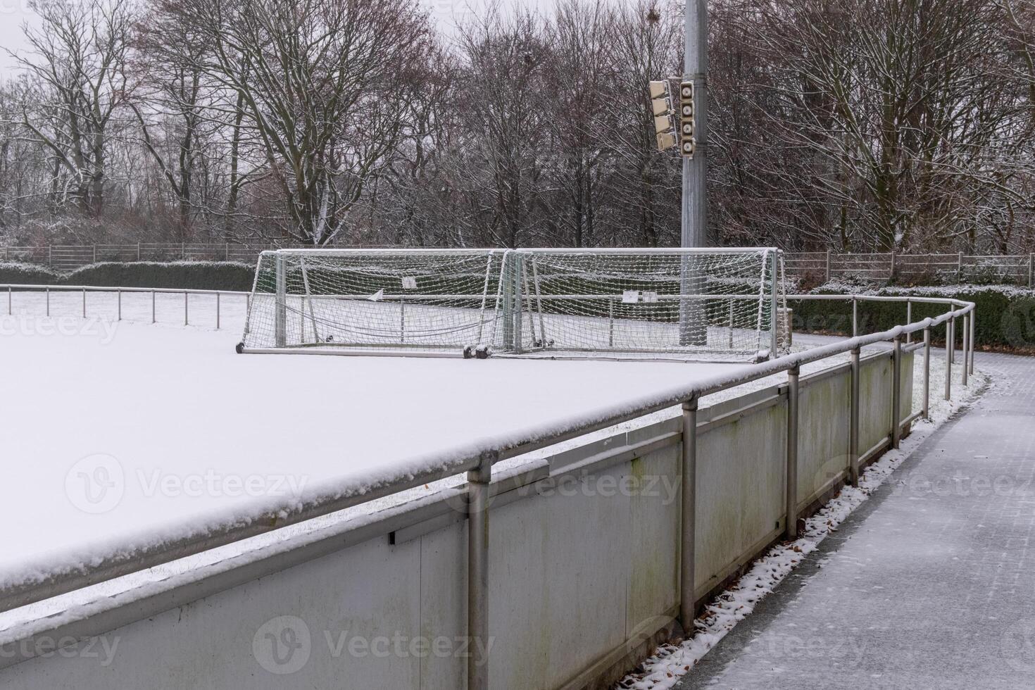Soccer field covered with snow in winter photo