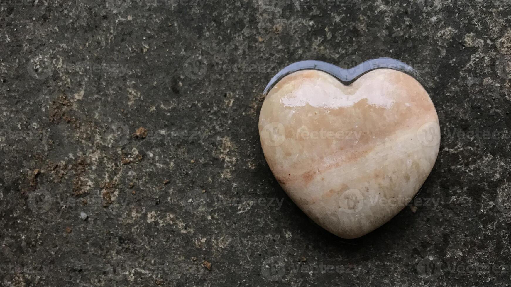 Heart-shaped stones placed on ground symbolize love, friendship and compassion for friends, lovers and family. Friendship, love and kindness concept using heart symbols to represent love. photo