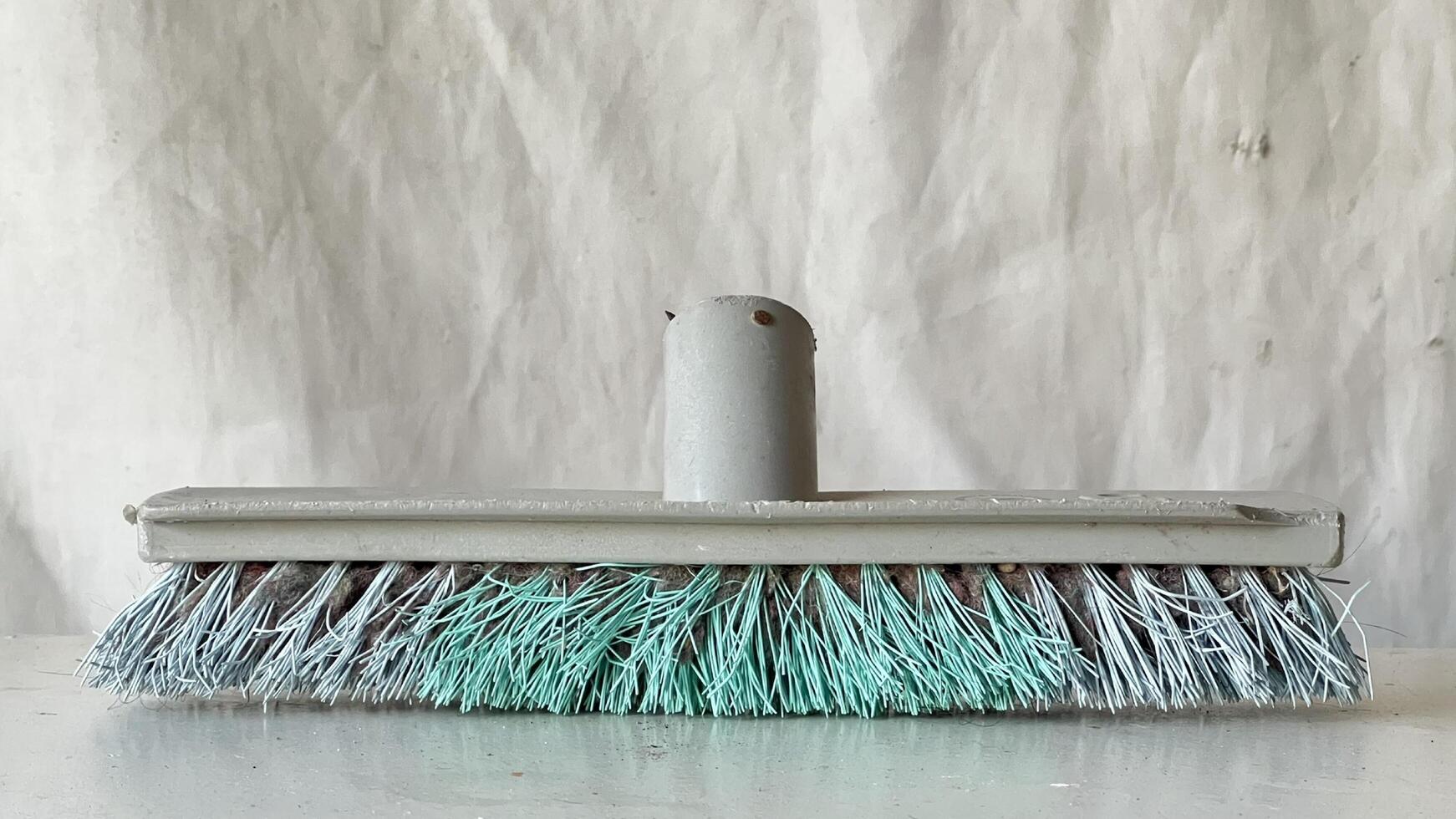 Cleaning tool with soft bristles on a plain background in a work environment photo