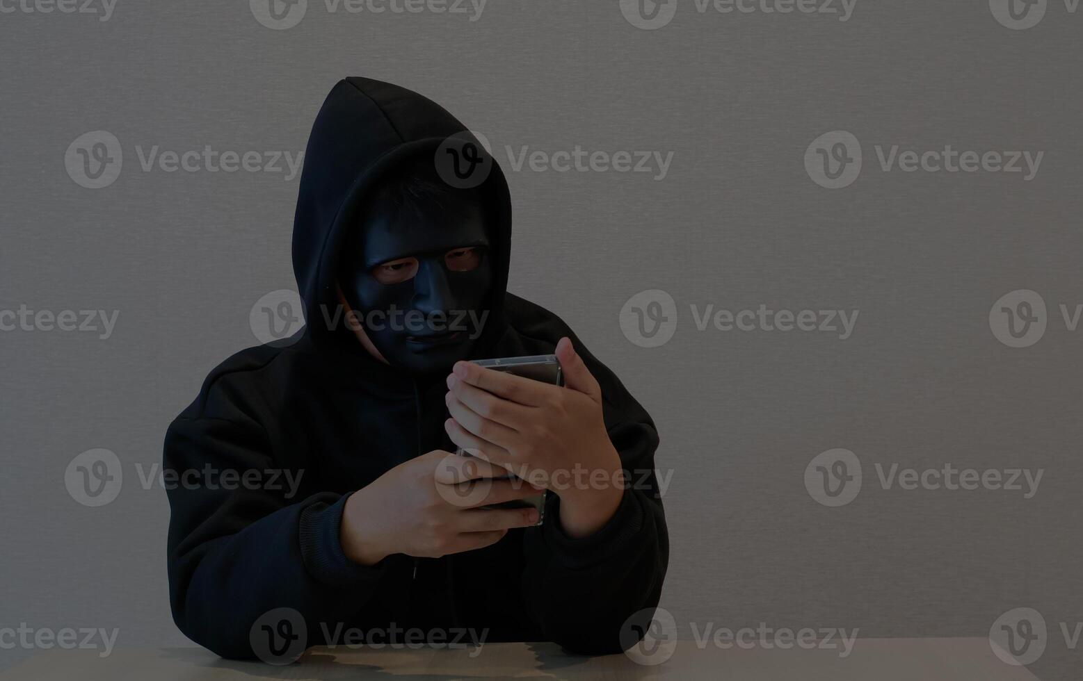 Phone Scammers, masked individuals holding phones, hackers accessing bank account information, criminal networks stealing information through call centers photo