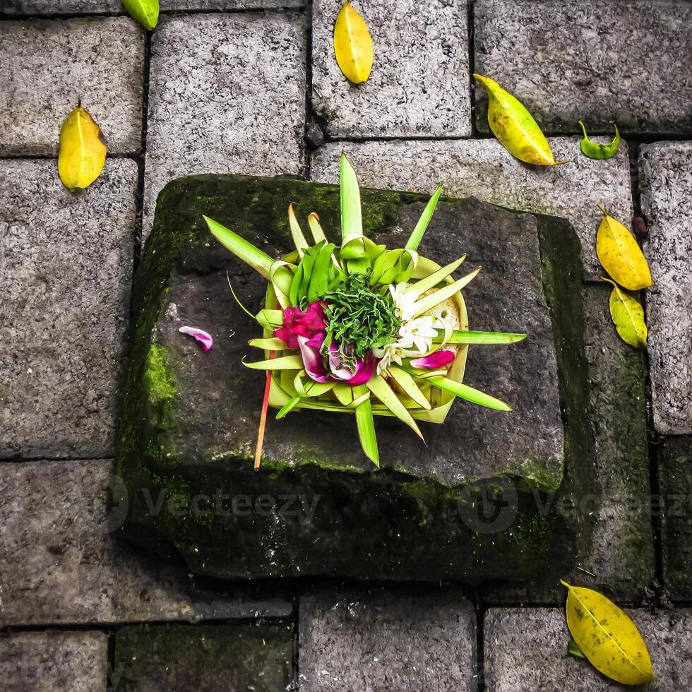 Balinese Hindu offerings, called Canang, are intricate arrangements of flowers, rice, and other symbolic items presented in woven palm leaf trays photo