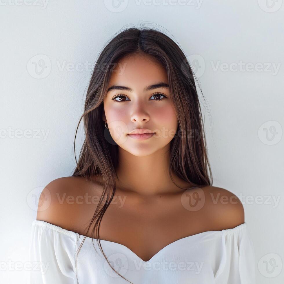 Beautiful young woman with long hair posing in front of white background photo