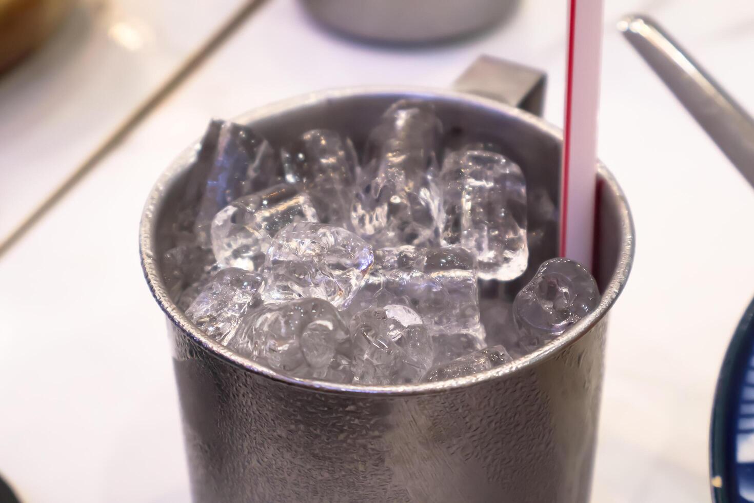 Glass with ice cubes and straw. Close up and Top view photo