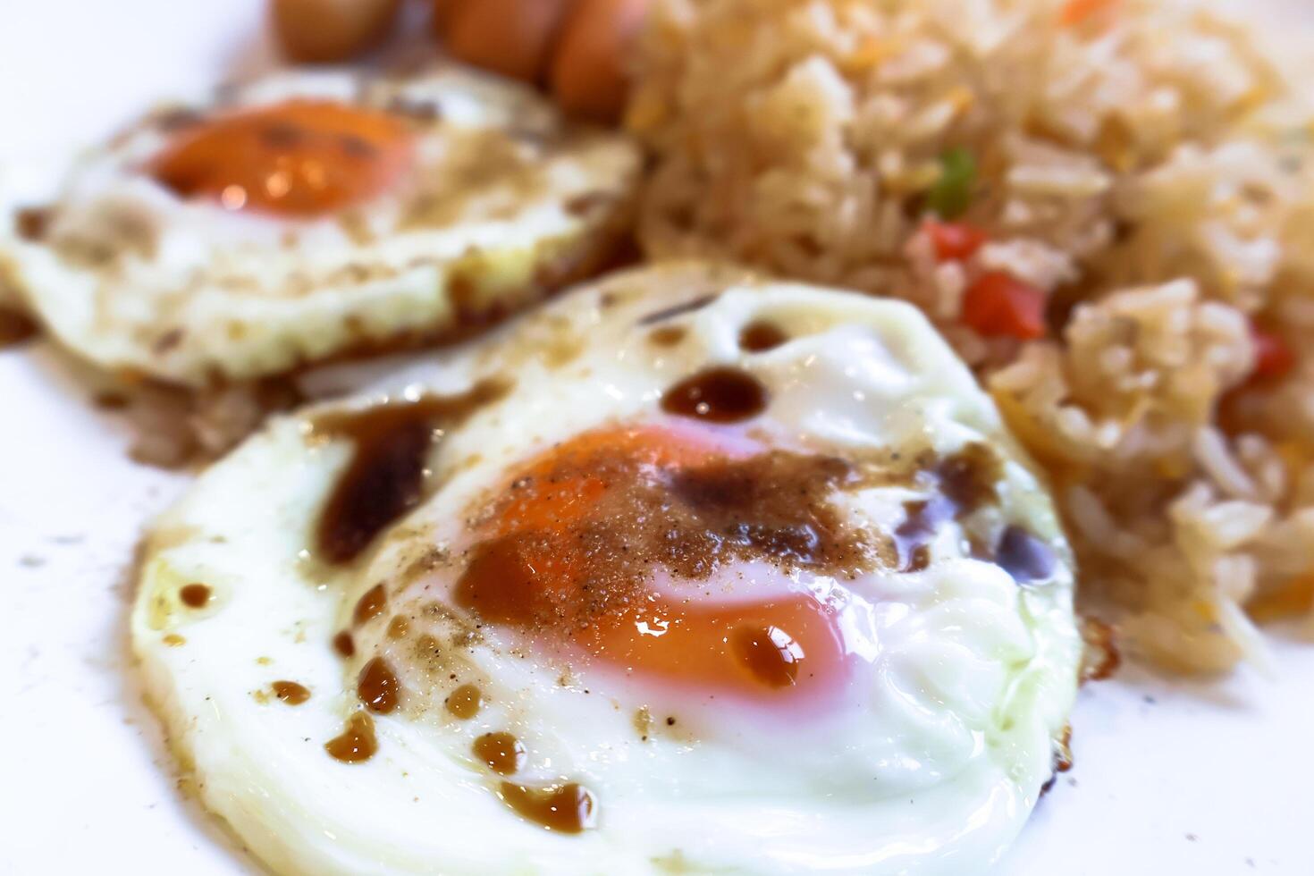 Closeup side view of fried egg with soy and pepper. photo