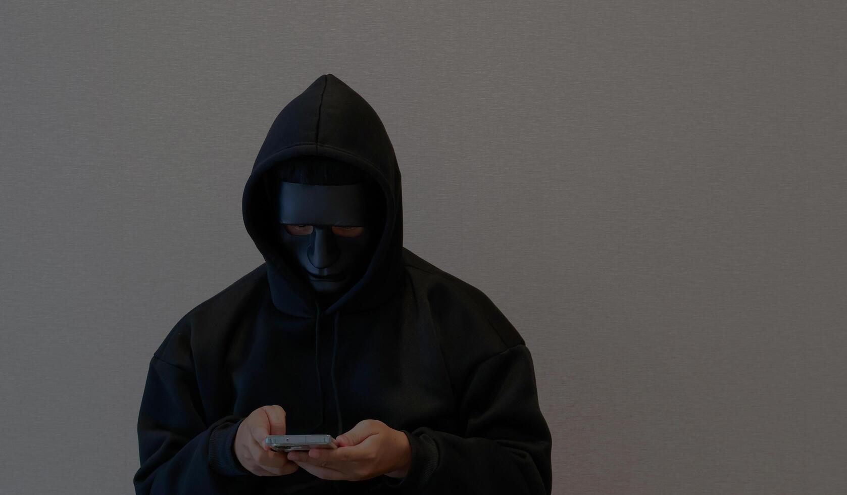 Scammers, masked individuals holding phones, cyber scams, hackers accessing bank account information, criminal networks stealing information through call centers photo
