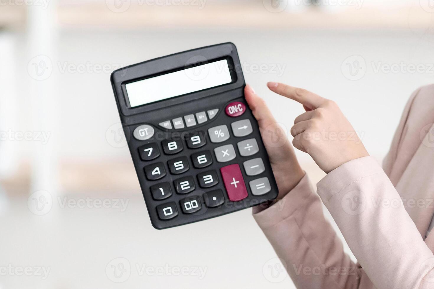Tour Agent Woman Showing Calculator With Price To African American Family Couple Offering Tour Sitting In Office, Wearing Protective Face Masks. Great Travel Offer. Selective Focus photo