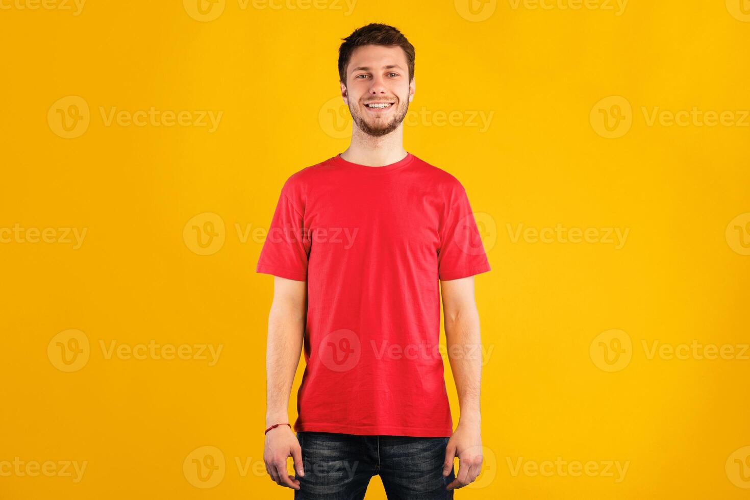 Portrait of handsome bearded man smiling, looking and posing at camera isolated over blue studio background. Confident caucasian guy with happy facial expression showing positive emotions photo