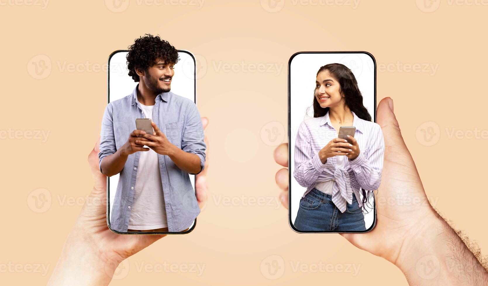 A couple holds smartphones, engaged in a joyful conversation. They smile at each other, showcasing love and affection despite the distance, highlighting modern communication through technology. photo