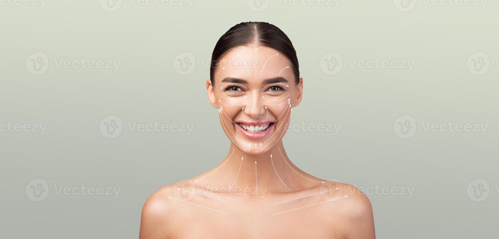 A woman is smiling while embracing her skin care routine. Her bare shoulders and radiant skin suggest relaxation and self-care in a peaceful, minimalist setting. photo