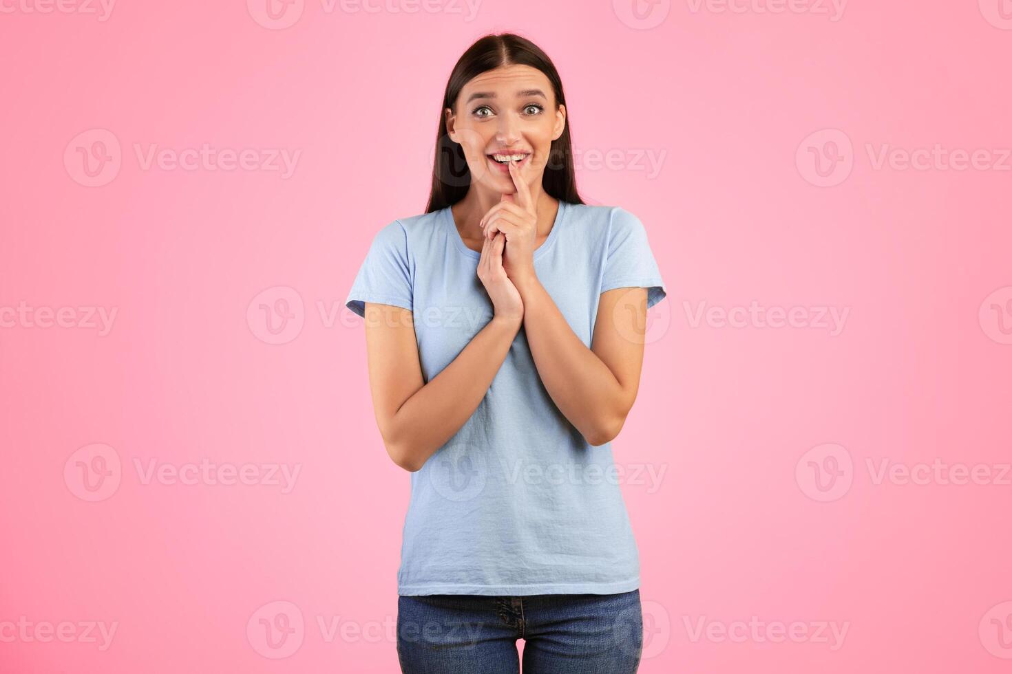 Anticipation And Expectation Concept. Portrait Of Emotional Smiling Young Lady Waiting For Something, Amazed Impressed Woman Looking At Camera, Standing And Posing Over Yellow Studio Background photo