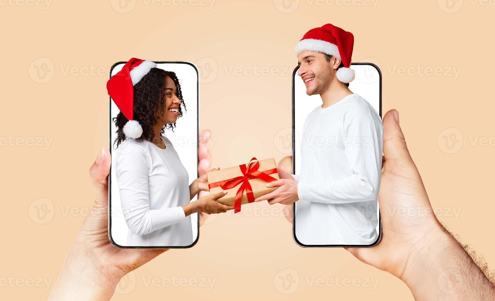 A couple exchanges a gift while wearing festive hats, showcasing their love through technology. photo