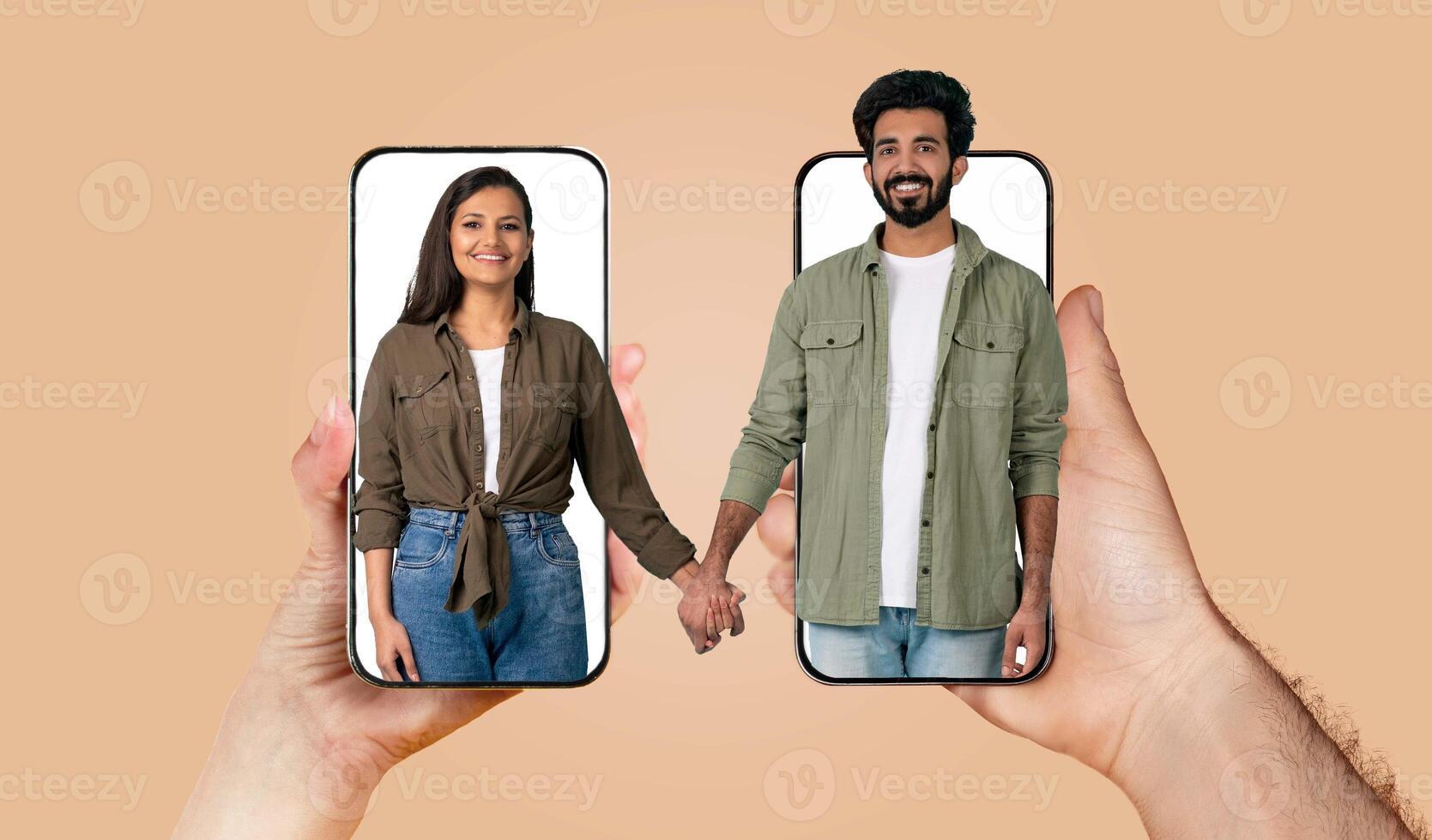 A couple expresses their love and connection by holding hands on their smartphones. They are engaged in an online conversation, highlighting modern relationships and communication. photo