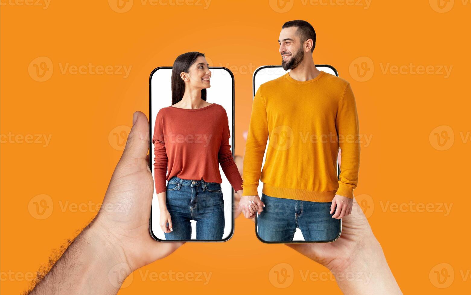 A couple shares moments of love and connection while holding hands. They are engaging with each other using their smartphones, showcasing modern communication in a cheerful environment. photo