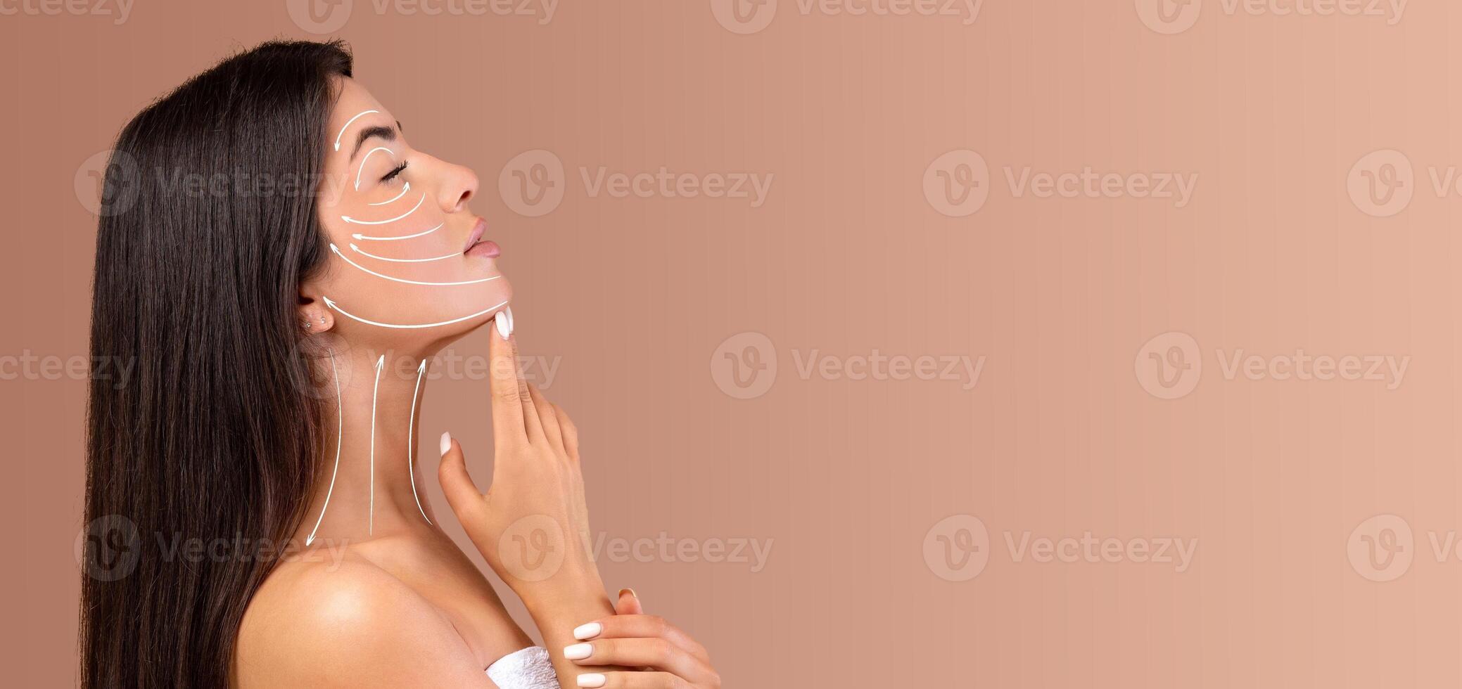 A lady is applying skin care products on her face, focusing on a relaxing beauty routine. She is in a tranquil setting with soft, neutral tones, creating a peaceful atmosphere for pampering. photo