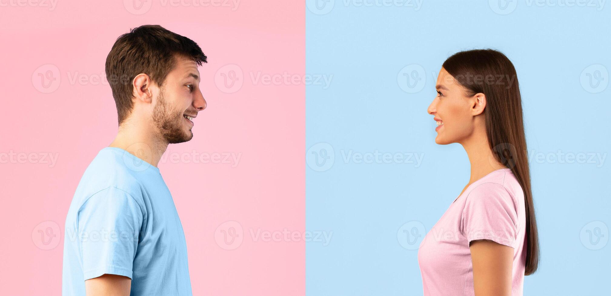 Profile portrait of casual woman and bearded smiling caucasian man posing isolated over blue and yellow studio background. Side view of positive couple standing and looking at each other photo