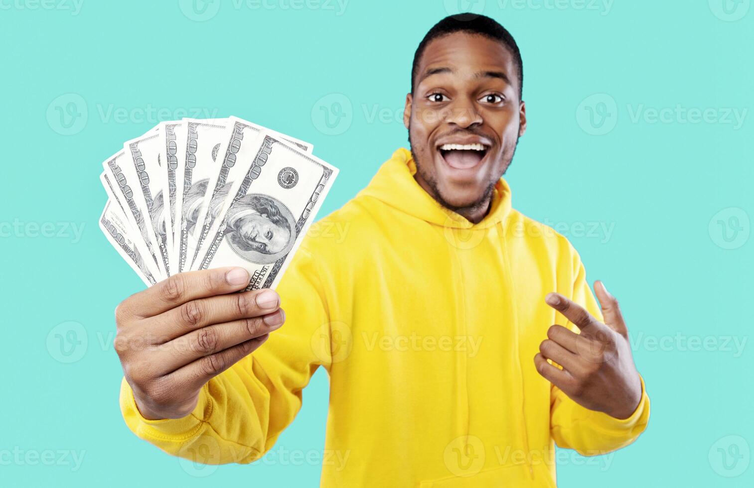 Big Financial Success. Excited African Guy Showing Dollar Money Cash Over Blue Studio Background. I'm Rich. Profit And Income, Abundance Concept. Selective Focus photo