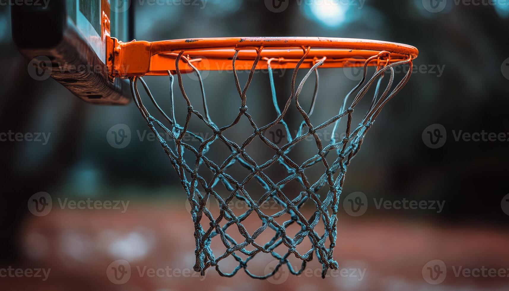 Basketball hoop hangs in an outdoor court with a blurred background on a cloudy day photo