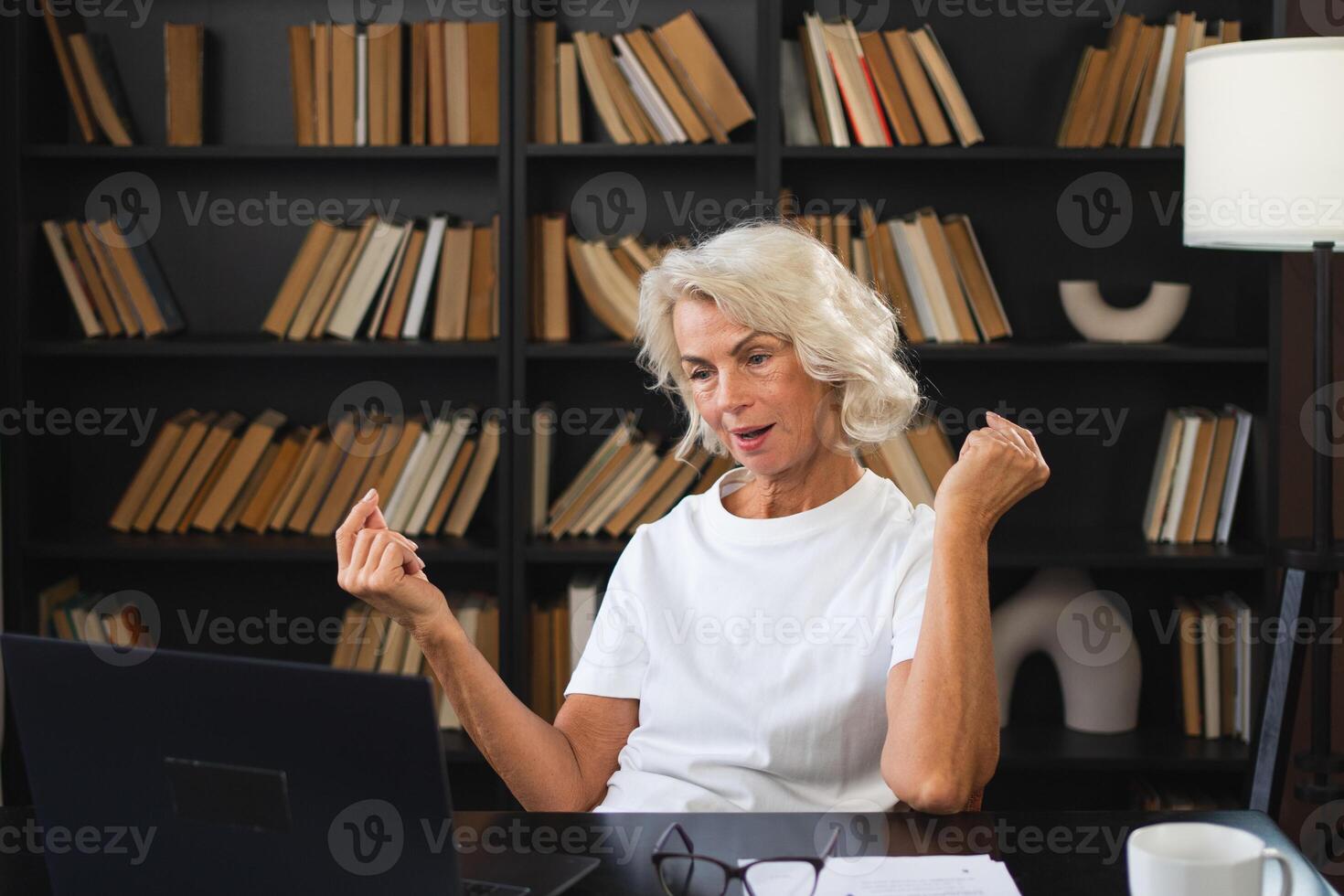 call. Happy middle aged senior woman sit with laptop talk on call. Mature old senior lady having fun talking speaking online. Older generation modern tech usage Virtual meeting online chat photo