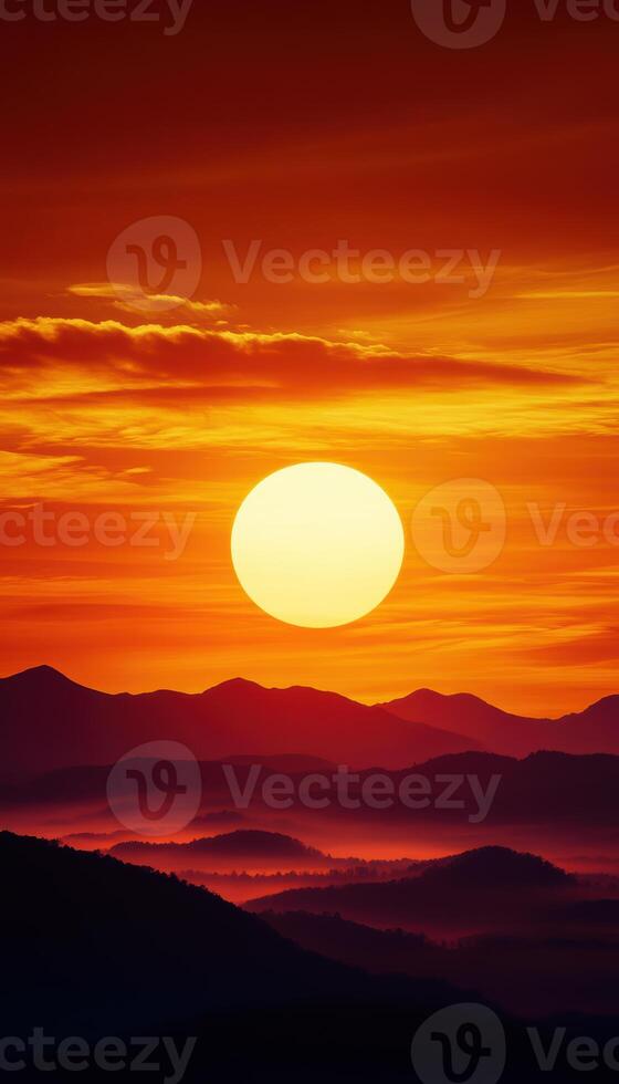 A large sun is setting over a mountain range photo