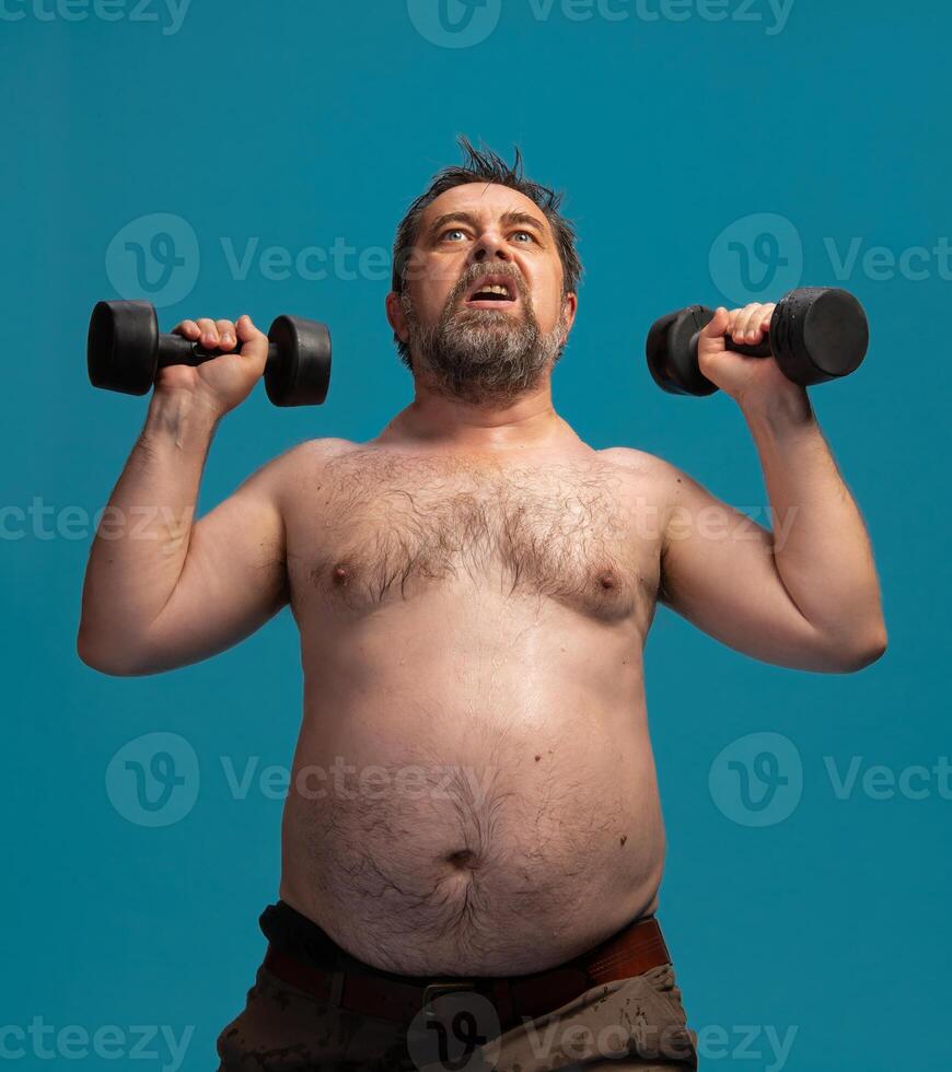 Elderly man lifts dumbbells for strength training in home gym setting photo