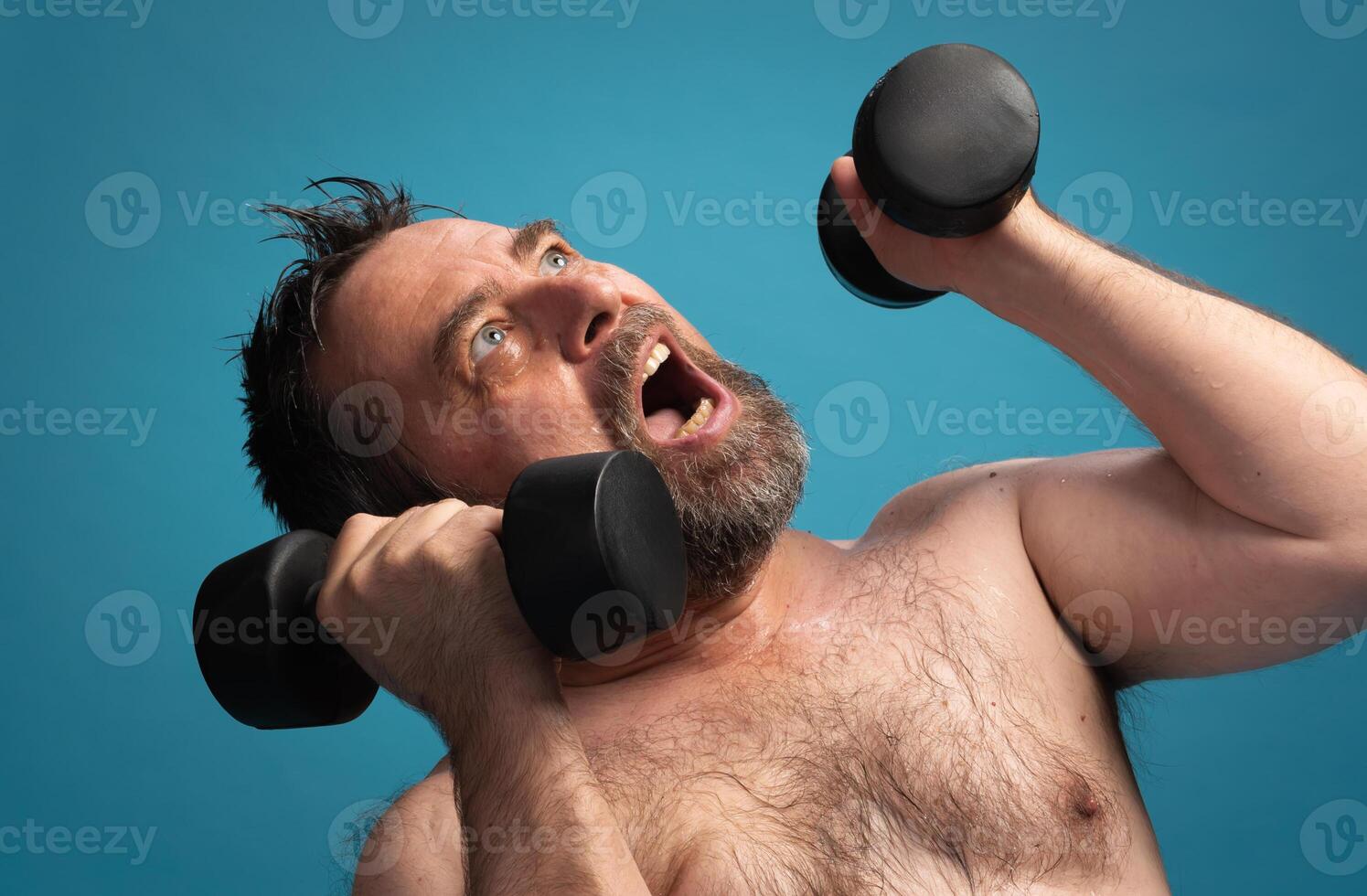 Elderly man workouts with dumbbells for strength and fitness at a bright indoor location photo