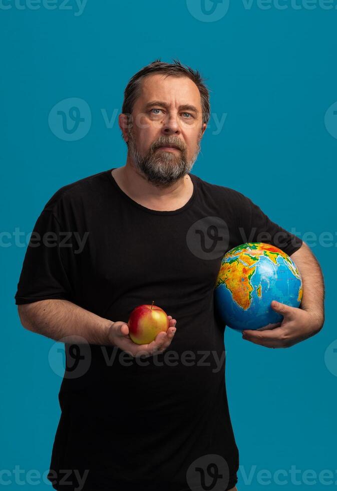 Balancing knowledge and nature with an apple and a globe in a vibrant backdrop photo