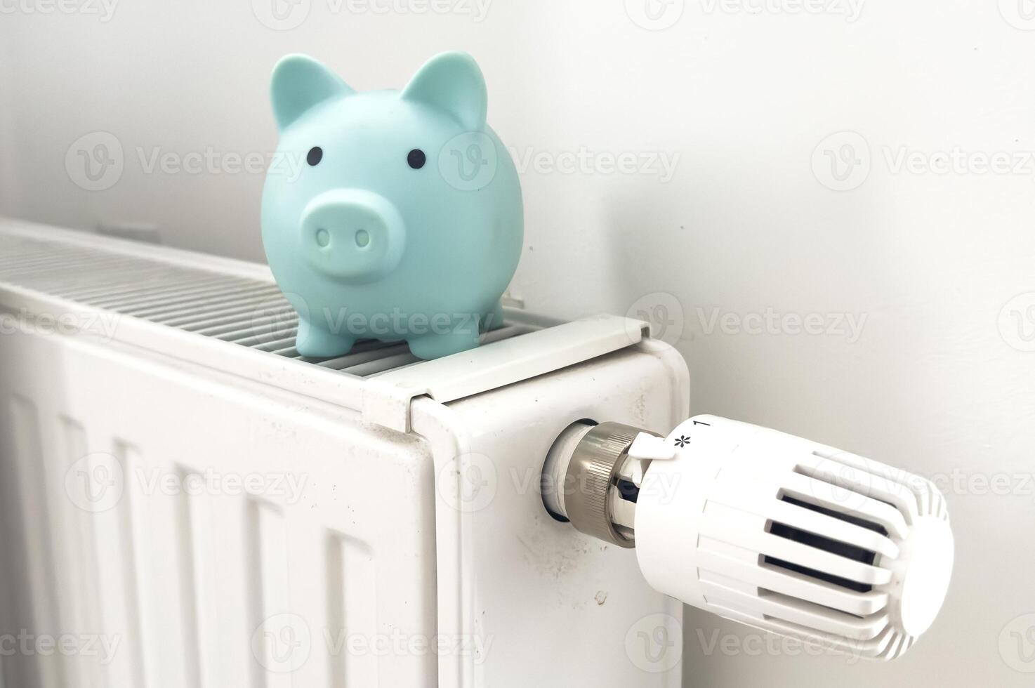 Piggy bank on radiator. Saving heating in winter photo