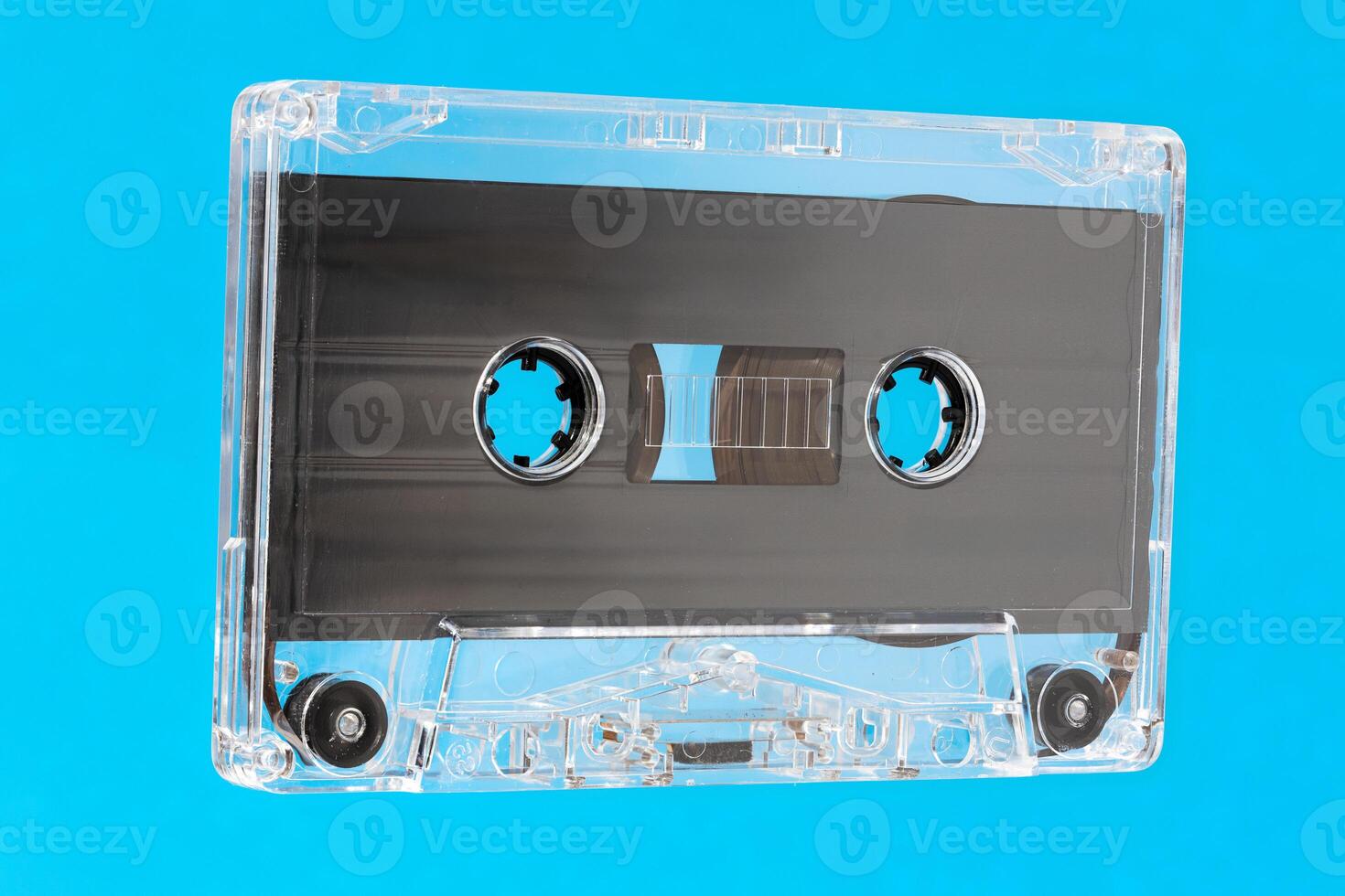 Audio tape cassette isolated on blue background. Template mock up photo