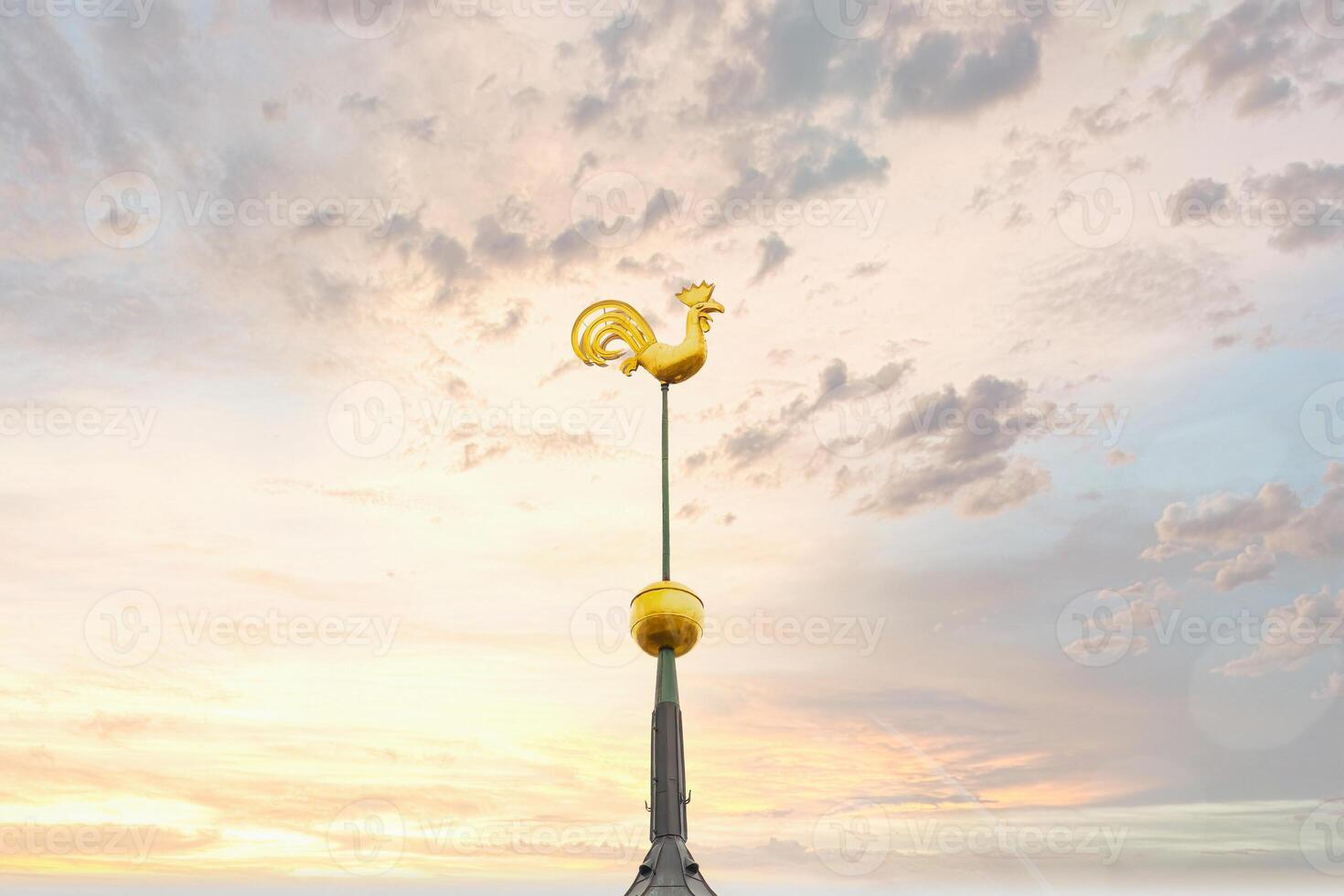 Golden Rooster Weather Vane on St. Peter's Church Spire at Sunset photo