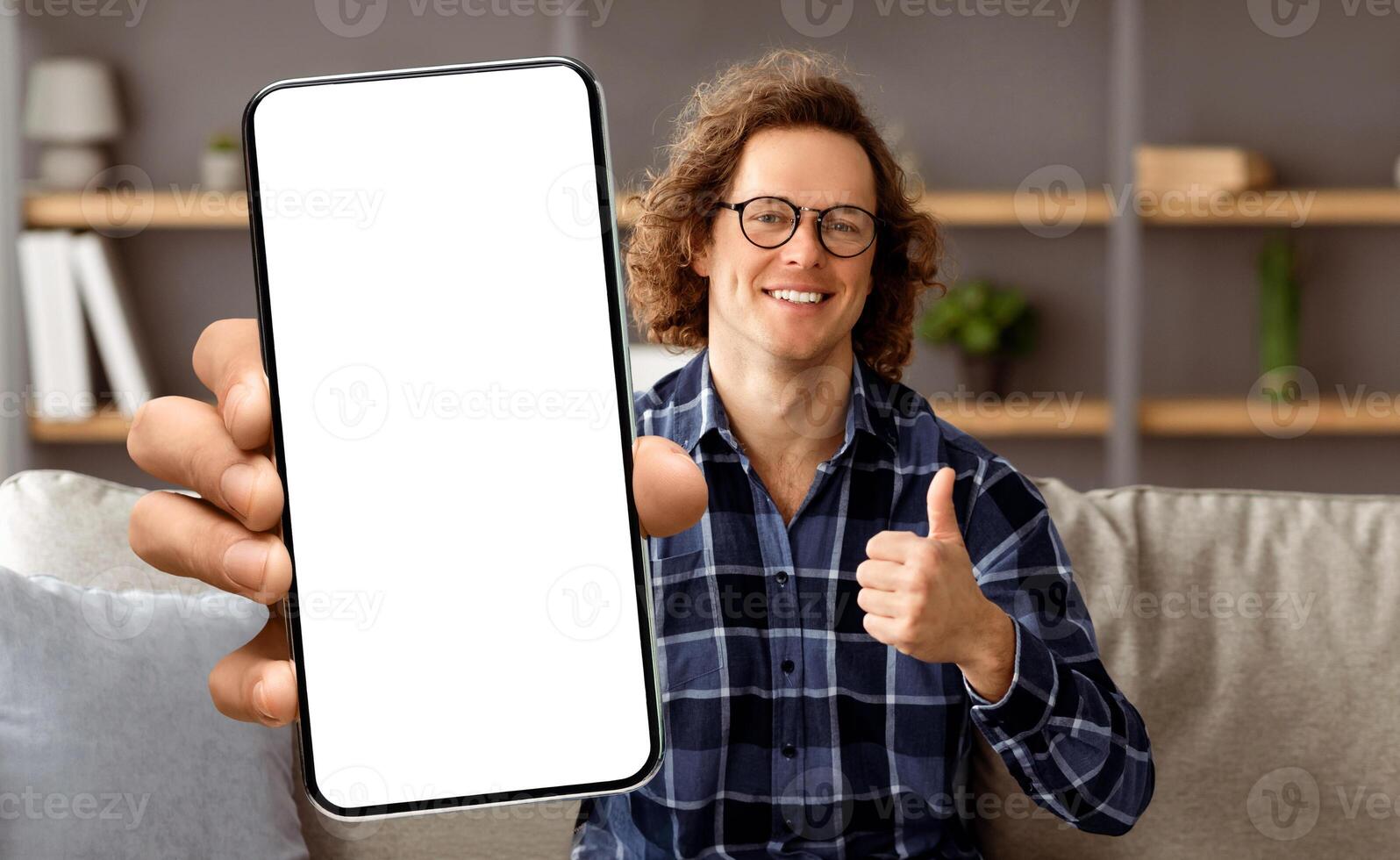 Happy Freelancer Guy At Laptop Gesturing Thumbs Up Approving Freelance Career Posing Sitting On Sofa At Home, Smiling To Camera. I Like Distant Job And Work Online Concept photo