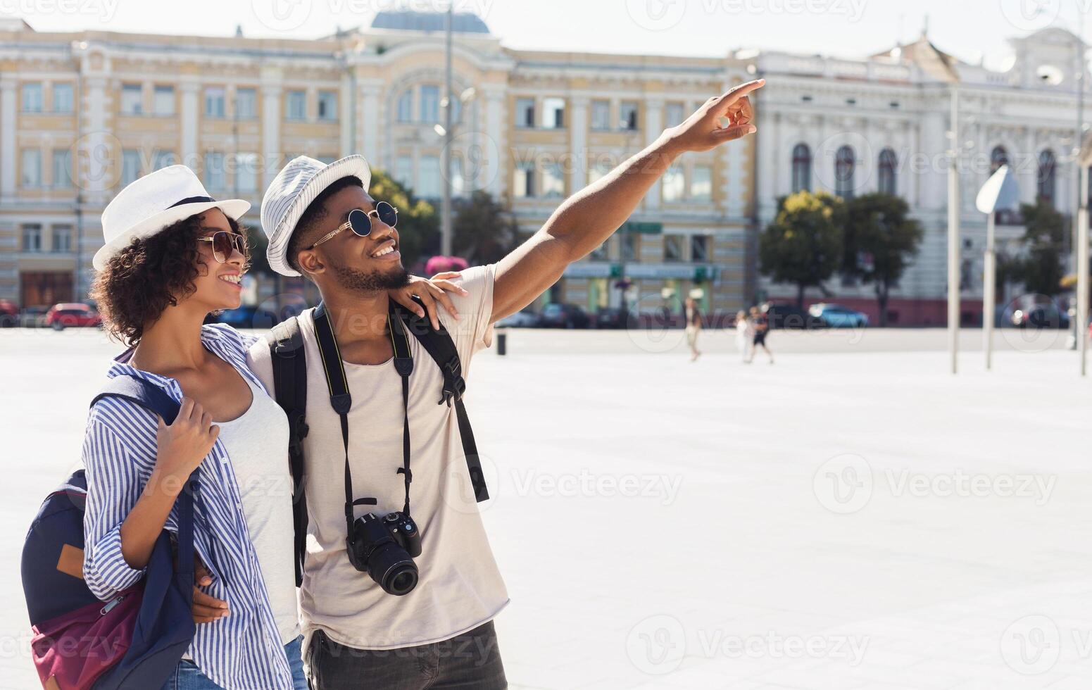 African-american couple of tourists sightseeing in city, copy space photo