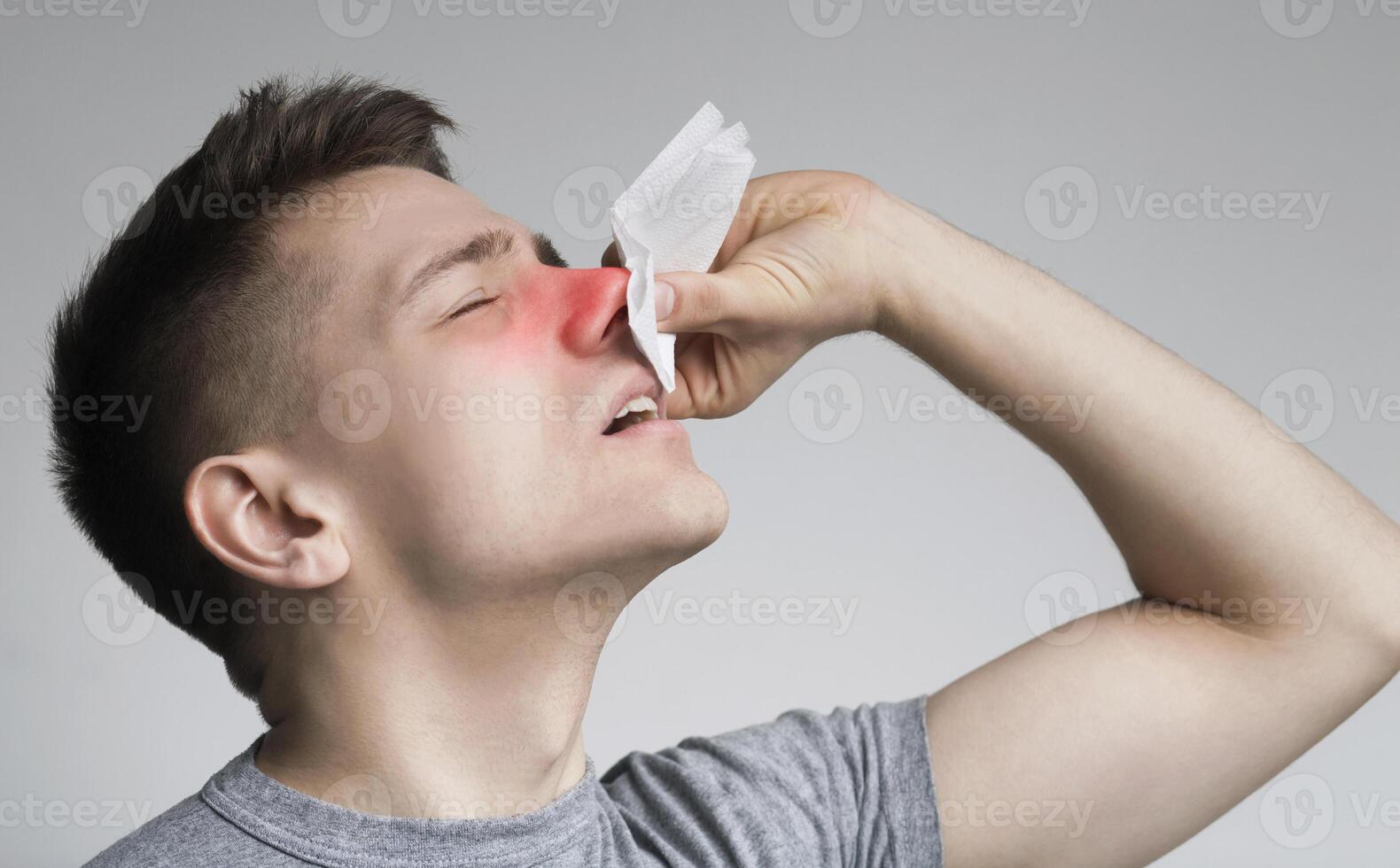 Young man with nosebleed or epistaxis, black and white photo, empty space photo