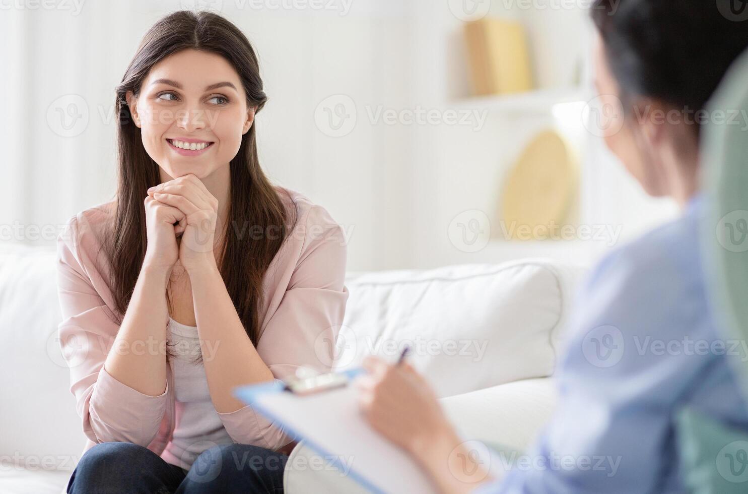 Smiling woman talking to wellness coach about motivation and happiness, free space photo