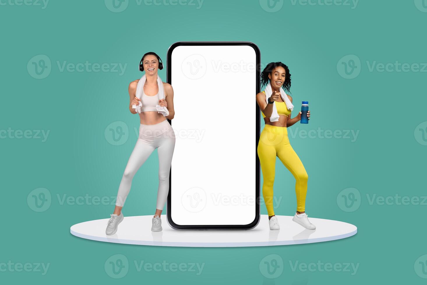 Two women dressed in workout clothes engage in fitness activities beside a large blank smartphone display. The vibrant environment showcases their dedication to health and fitness. photo