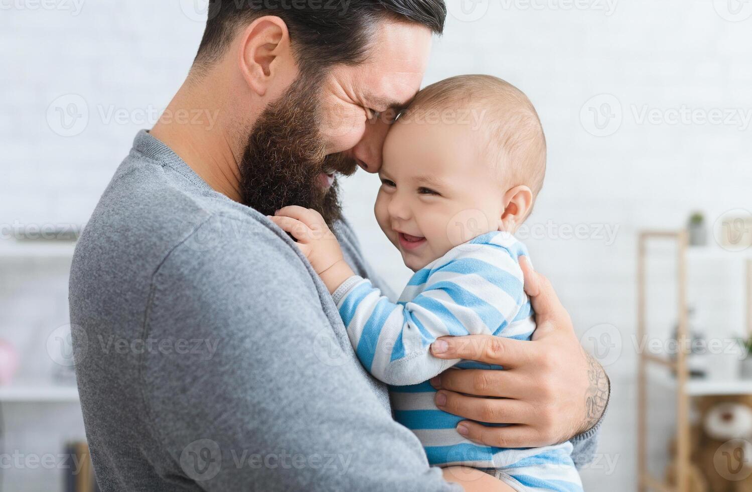Family love and joy. Happy father embracing with his laughing adorable baby photo