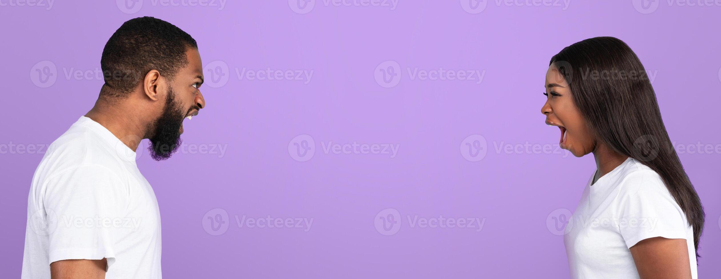 Scandal, Relationship Crisis Concept. Side view profile portrait of African American couple arguing, angry displeased black woman and man screaming at each other, blue studio background, banner photo