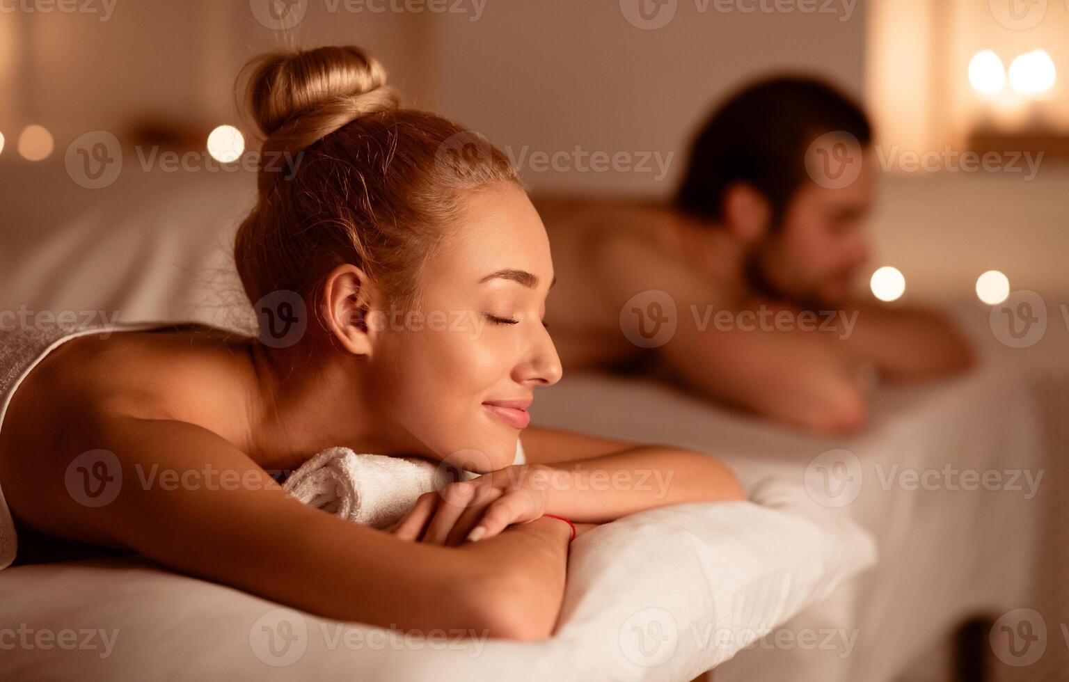 Spouses Resting After Relaxing Massage Therapy Lying With Eyes Closed In Luxury Spa Resort. Aromatherapy, Beauty, Wellness And Relaxation Treatment Concept. Low Light, Selective Focus photo
