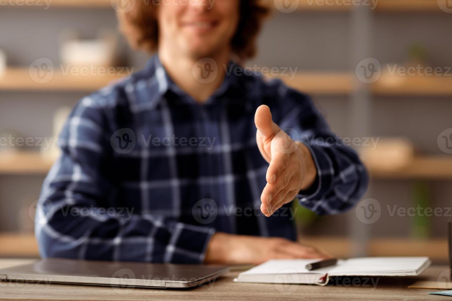 Employment. HR Manager Man Stretching Hand For Handshake Greeting To Camera Sitting At Desk In Modern Office. Job Interview, Agreement And Deal Concept. Selective Focus On Arm. Cropped photo